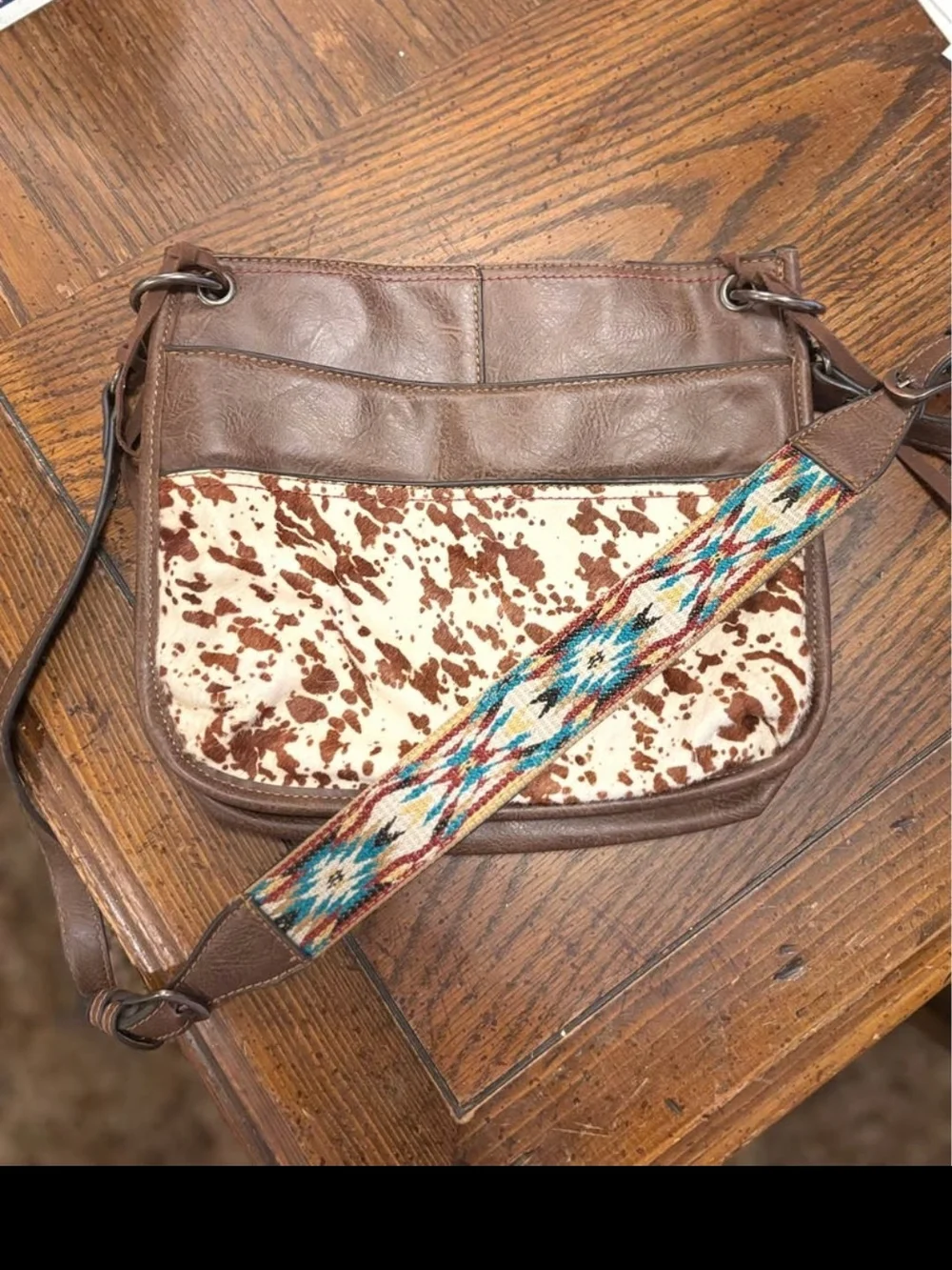 Brown Leather Crossbody Bag with Cowhide Accent and Patterned Strap